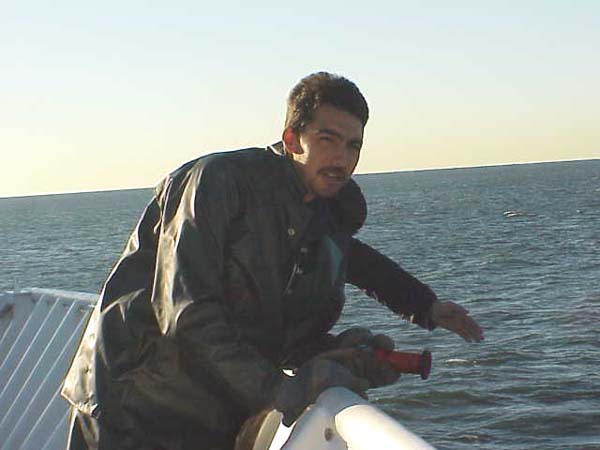 Chris, a member of the deck department poised and ready to spray off the anchor