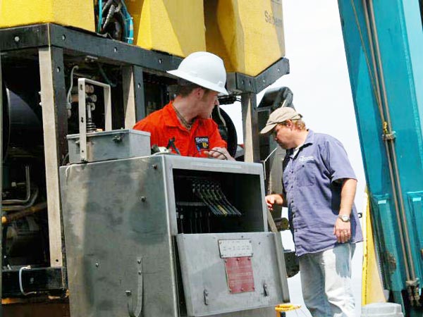 Lucas Cribley and Geoff Ellett making adjustments to the ROV