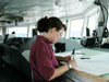 NOAA Corps Officer LTJG Jennifer Pralgo looking over a navigational chart