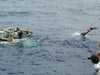 Sub crew member Jim Sullivan dives from the R/V Seward Johnson to the JSL II