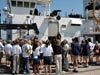 Students and teachers gather on the dock