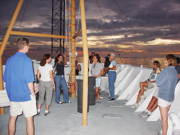 Members of the crew and science party enjoy a fiery sunset