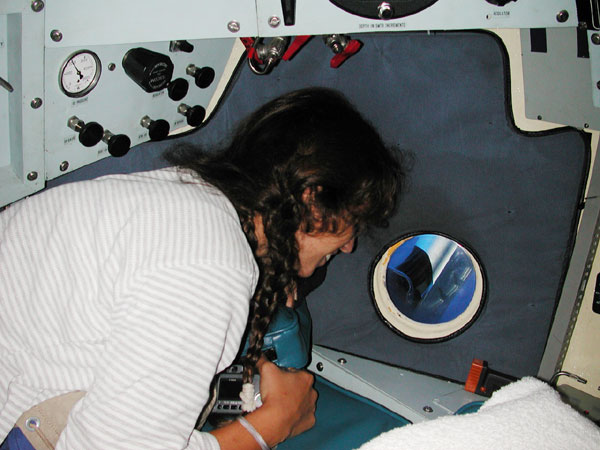 Undergraduate Carole Berini observing marine life through the port window.