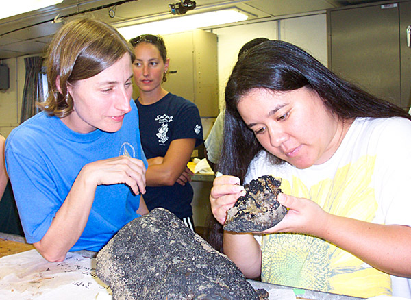 Examining a rock collected from approximately 3400 m water depth