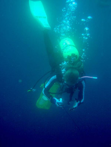 Blue water divers use glass jars to capture gelatinous specimens for further study in the ship’s laboratory.