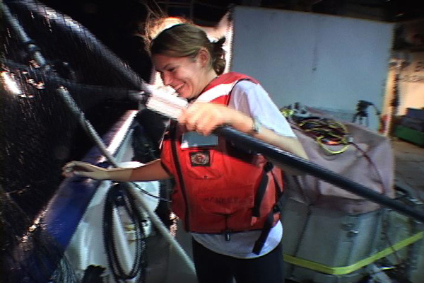 Jennie McClain immediately after the halfbeak she caught slipped through
the net mesh and back into the water.