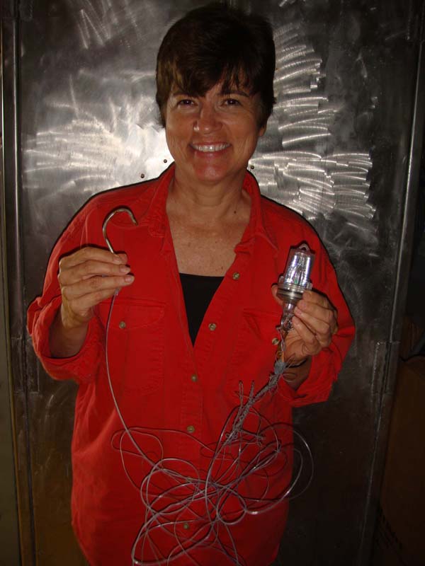 Dr. Edie Widder holds the mystery hook and lure found near the capsized EITS. 