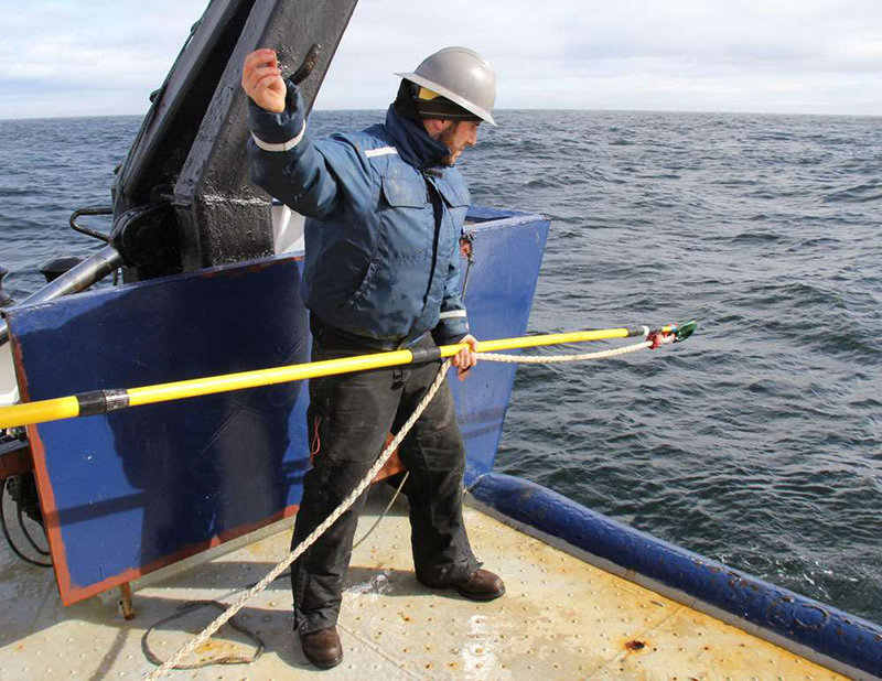 Jeff DiPietro waits to hook a mooring.