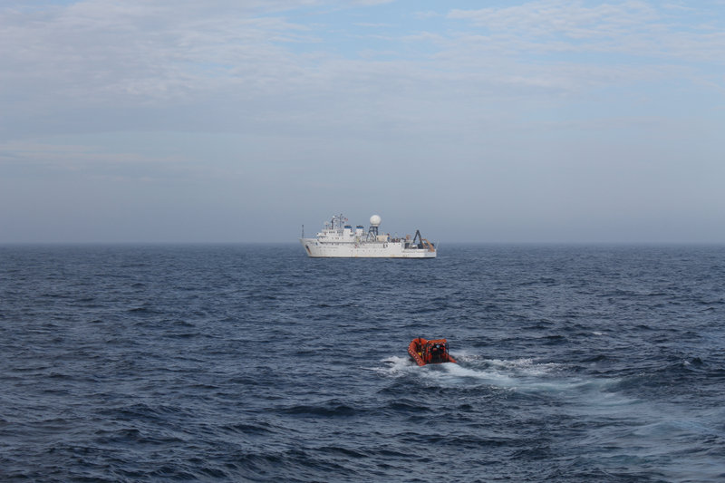 After an early morning radio call, NOAA Ship Okeanos Explorer met NOAA Ship Ronald H. Brown to deliver the replacement part for the EM122 multibeam sonar.