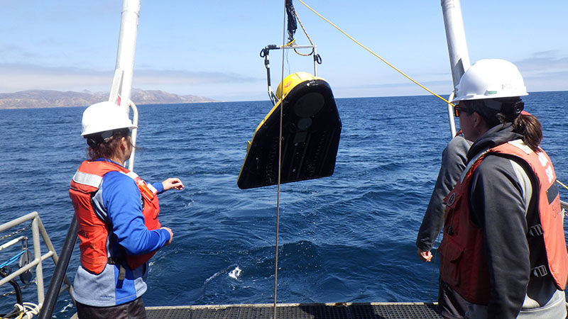 Paleolandscapes, Paleoecology, and Cultural Heritage on the Southern California Continental Shelf expedition team members Jillian Maloney and Shannon Klotsko on a previous expedition retrieving a chirp sub-bottom profiler. Some of the data from this previous expedition, funded by the Bureau of Ocean Energy Management, were used to target areas of interest for the current survey on the submerged landscape of Santarosae.