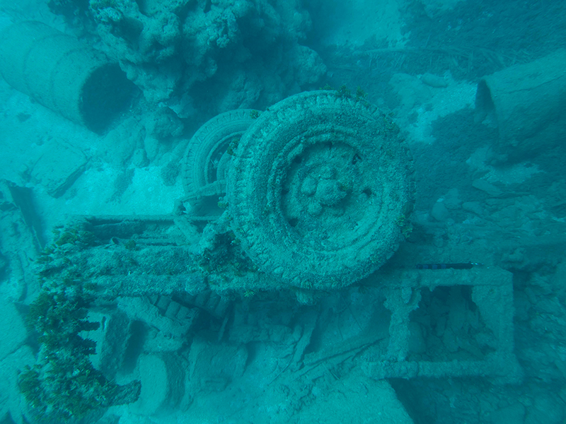 A World War II-era jeep trailer loaded with vehicle parts and equipment see off Agat Beach.