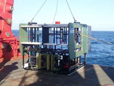 The In-Situ Ichthyoplankton Imaging System Deep-Focus Particle Imager (ISIIS-DPI) on the deck of Research Vessel <i>Sikuliaq</i>. This tool enabled the team to “sample” organisms without physical contact in their natural environment during the Exploring Pelagic Biodiversity of the Gulf of Alaska and the Impact of Its Seamounts expedition.