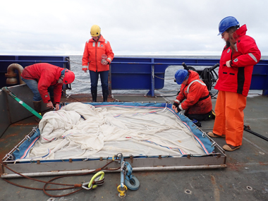 Team members prepare the Methot trawl for deployment during the Exploring Pelagic Biodiversity of the Gulf of Alaska and the Impact of Its Seamounts expedition.