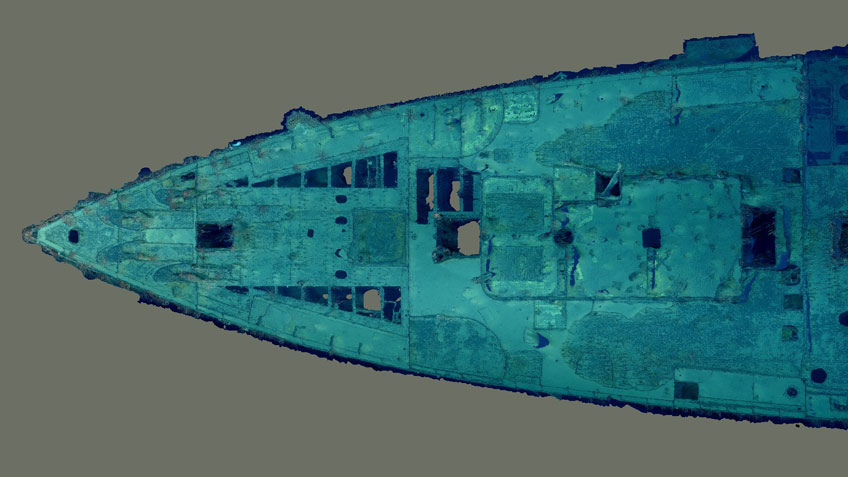 Top-down view of a photogrammetry model of the shipwreck of the bow section of USS Baltimore (C-3) in blue and green hues.