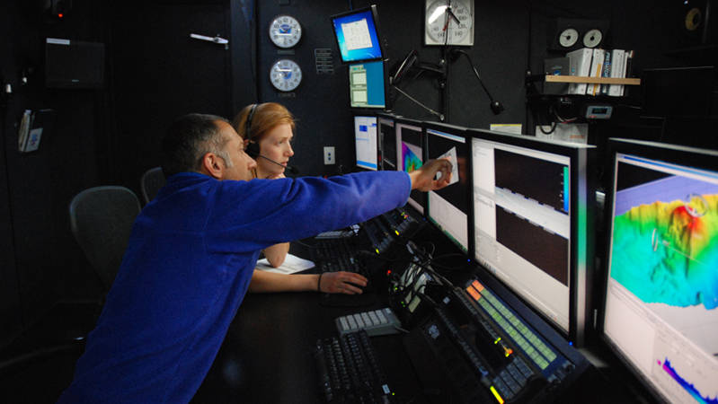 Mike Barber and Kate von Krusenstiern process and clean data during the transit north to dry dock.