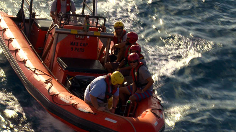 Okeanos Explorer’s Fast Rescue Boat returns to the ship with the four Monk Seal researchers safely onboard.