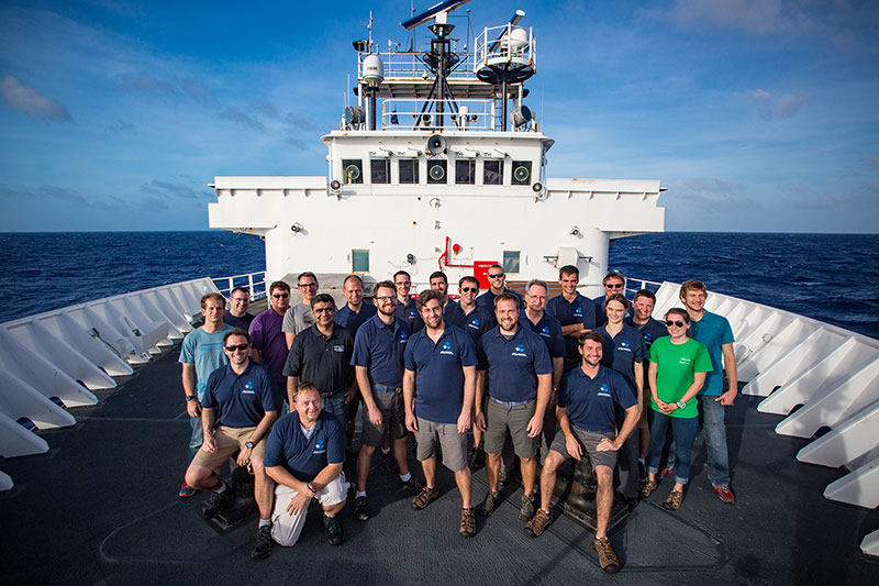 The at-sea team poses for a picture on the bow of the ship.