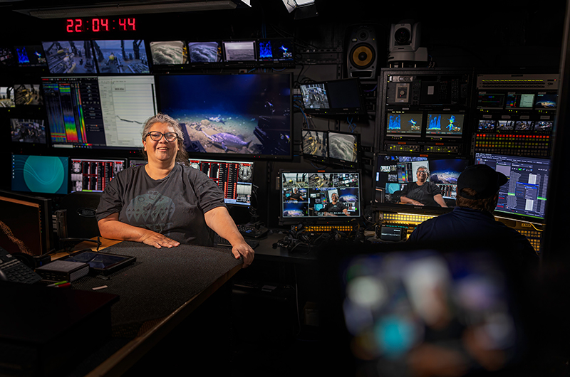 Mia Lopez from the Coastal Band of the Chumash Nation in the control room of NOAA Ship <i>Okeanos Explorer</i> during a live land acknowledgement.